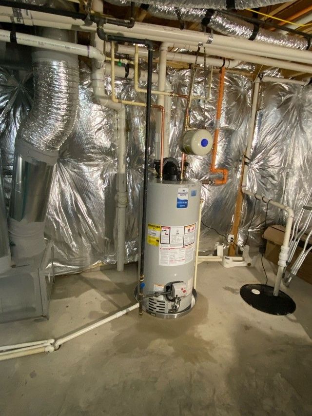 Tank water heater in a basement utility room